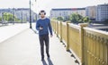 A man is walking near the river on a yellow bridge Royalty Free Stock Photo