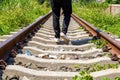 A man walking on old rusty railway tracks outdoors Royalty Free Stock Photo