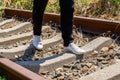 A man walking on old rusty railway tracks outdoors Royalty Free Stock Photo