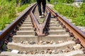 A man walking on old rusty railway tracks outdoors Royalty Free Stock Photo