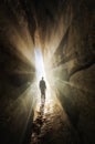 Man walking out of a cave into the light Royalty Free Stock Photo