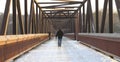 Man walking over footbridge Royalty Free Stock Photo