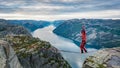 Man walking over the rope at Preikestolen, Pulpit Rock, Norway Royalty Free Stock Photo