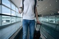 Man walking with paper coffee cup at airport terminal Royalty Free Stock Photo