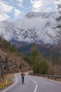 Man walking on a road with beautiful mountain view in Styria region, Austria