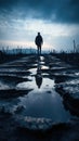 A man walking on a road with puddles in the middle. Generative AI image. Royalty Free Stock Photo