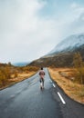 Man walking on the road travel in Norway outdoor autumn mountains view active vacations