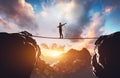 Man walking on rope between two high mountains Royalty Free Stock Photo