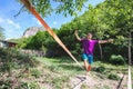 Man walking on a slack line. Royalty Free Stock Photo