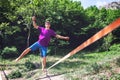 Man walking on a slack line. Royalty Free Stock Photo