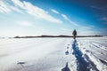 man walking in snow footprints Royalty Free Stock Photo