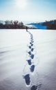 man walking in snow footprints Royalty Free Stock Photo