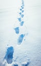 man walking in snow footprints Royalty Free Stock Photo