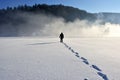 The Man walking on snow, footprints in snow, behind Royalty Free Stock Photo