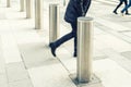 Man walking by stainless steel bollard entering pedestrian area on Vienna city street. Car and vehicle traffic access control Royalty Free Stock Photo