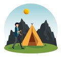 man walking with stick and camp with mountains and sun