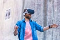 Man walking in the street in augmented reality headset. Virtual reality and futuristic technology concept.