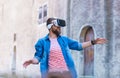 Man walking in the street in augmented reality headset. Virtual reality and futuristic technology concept.