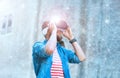 Man walking in the street in augmented reality headset. Virtual reality and futuristic technology concept.