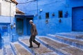 Man walking in a street of the town of Chefchaouen in Morocco. Royalty Free Stock Photo