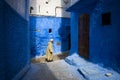 Man walking in a street of the town of Chefchaouen in Morocco. Royalty Free Stock Photo