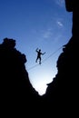 Man walking on tight rope over the rock Royalty Free Stock Photo