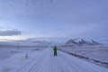 Man walking to mountain on the snow in Iceland.