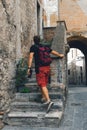 Man walking. Tourist. Narni Terni, Umbria, Italy, medieval city: a typical old street. Vertical photo. in action Royalty Free Stock Photo