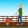 Man with walking tractor works at area