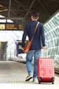 Man walking on train station platform with travel bag Royalty Free Stock Photo