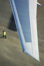 Man walking under airplane wing elevated view Royalty Free Stock Photo