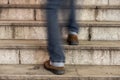 Man walking up an old stone staircase Royalty Free Stock Photo