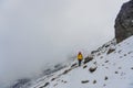 Man walking up snowy slope Royalty Free Stock Photo