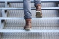 Man walking up stairs in boots Royalty Free Stock Photo