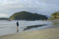 Man walking in the water on Tonquin Beach, Tofino