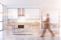 Man walking in white and beige kitchen Royalty Free Stock Photo