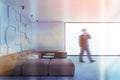 Man walking in white geometric pattern living room