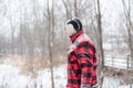 Man walking through woods on a snowy day