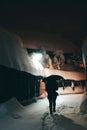 Man walkng on a snowy alley with an umbrella, at night Royalty Free Stock Photo