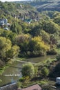 Man walks across a bridge over the Smotrych River in the canyon of Kamianets-Podilskyi Royalty Free Stock Photo