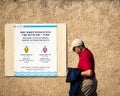 A man walks past a sign that reserves a beach in Tel Aviv for men or women on alternate days Royalty Free Stock Photo