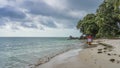 A man walks along the beach of a tropical island. Royalty Free Stock Photo