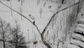 A man walks along a road cleared of snow in yard of city