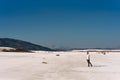 A man walks along the shore of lake Salda in Turkey. Single man walking alone into the desert. A man is walking in desert. Royalty Free Stock Photo