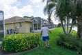 Man walking around garden to spray weeds