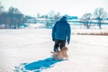 A man walks with a dog in deep snow