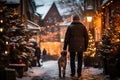 A man walks with a dog on a festive winter street