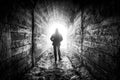 The man walks down the tunnel towards the light Royalty Free Stock Photo