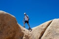 Man walks on the edge of the rock.Destination and exploring. Arch Rock Trail, Joshua Tree National Park, California, USA Royalty Free Stock Photo