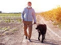 A man walks with his dog outdoors after Spain imposed a lockdown to slow down the spread of the coronavirus disease